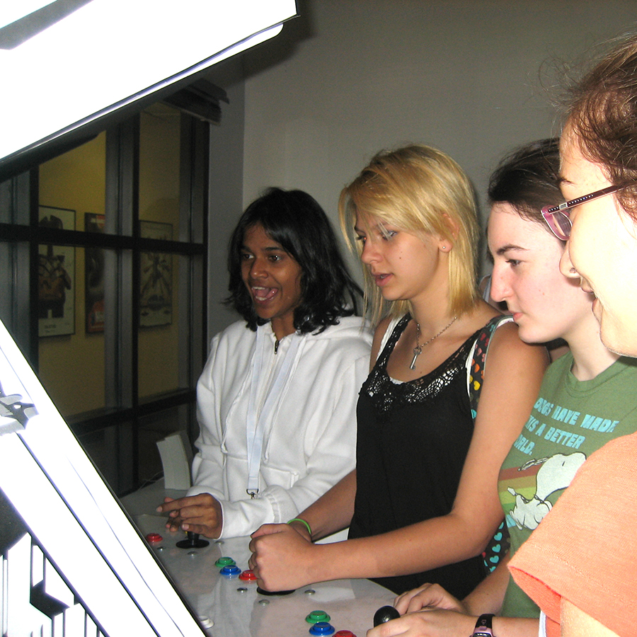 Students playing an arcade game