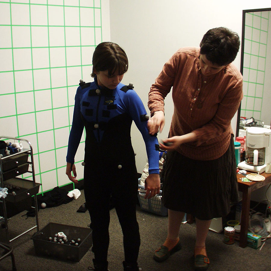 student getting equipped with motion capture suit