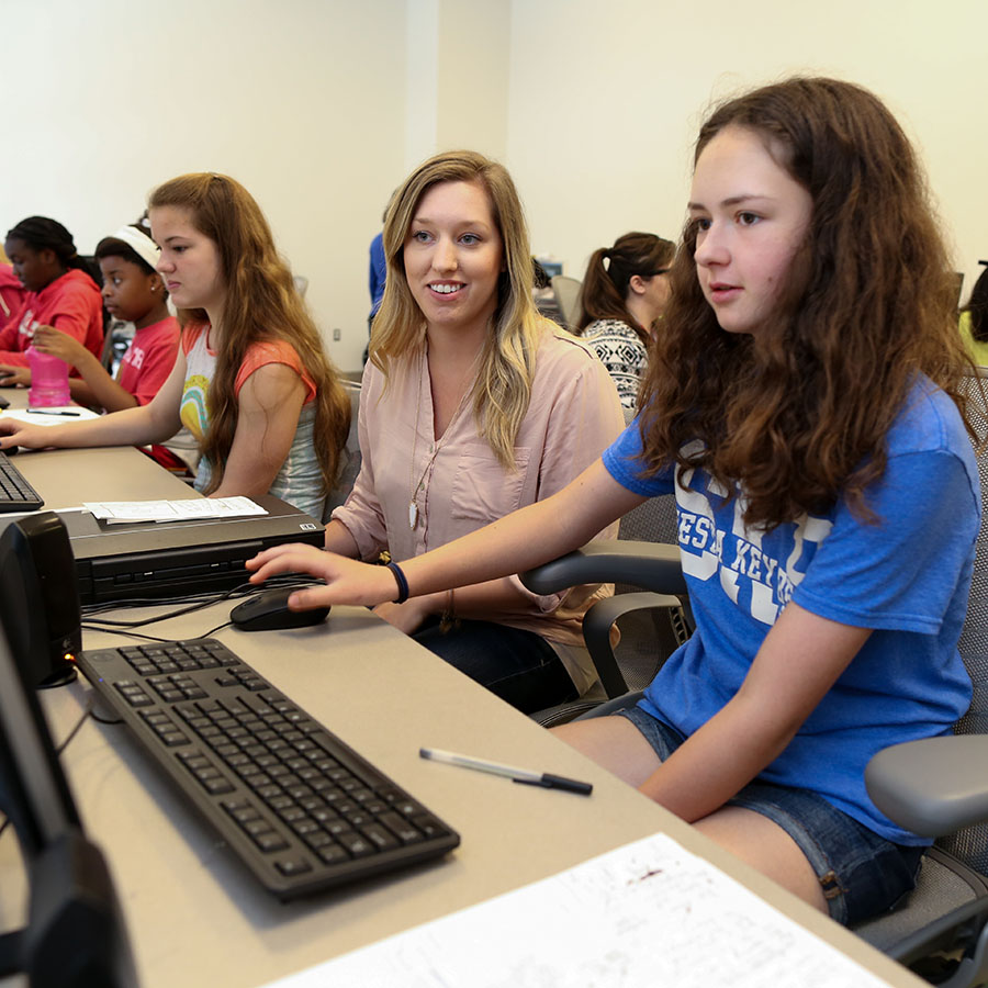 mentor and students in the computer lab