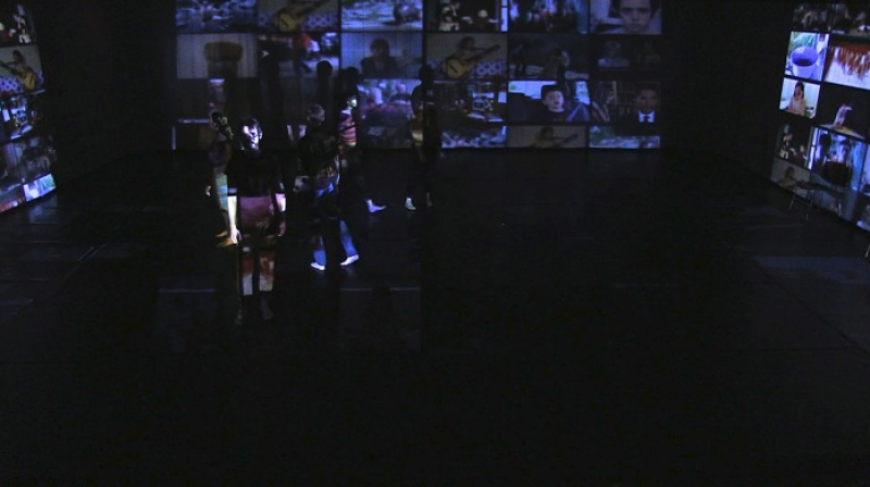 Actors on stage with multiple projected screens