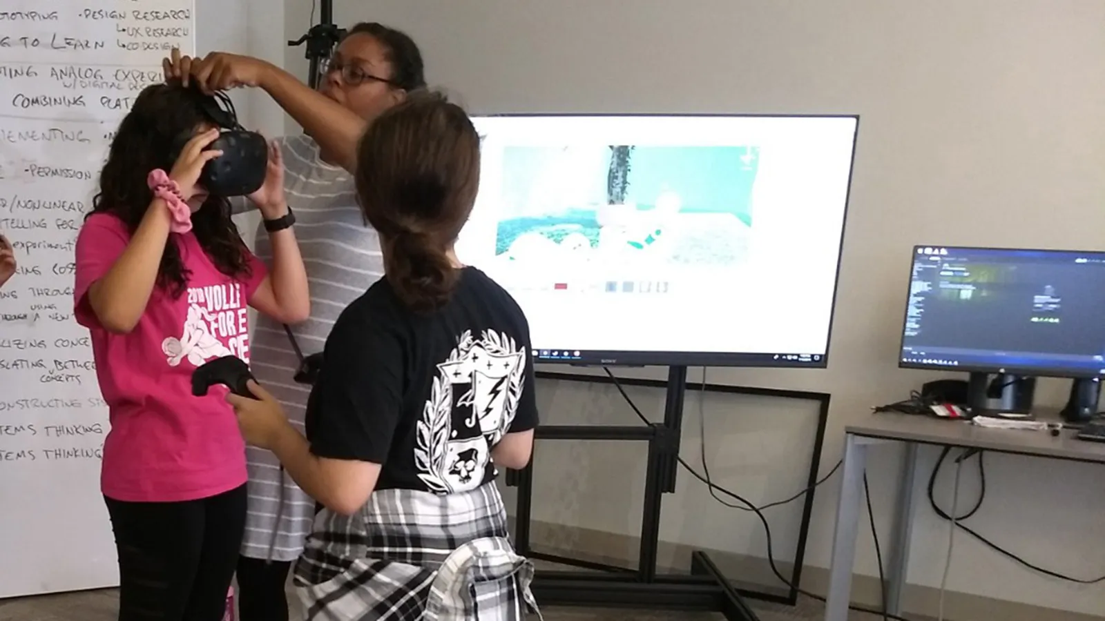 mentor helps student with VR headset