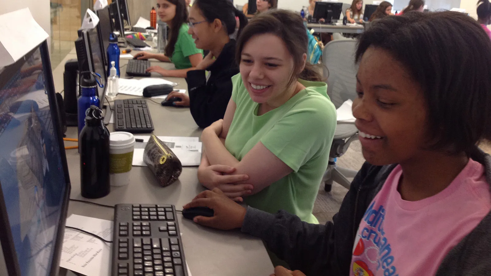 Students and mentor working at computers