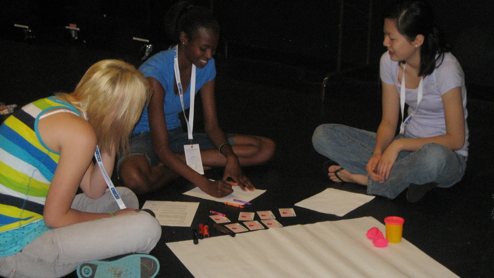 Three students working with art materials