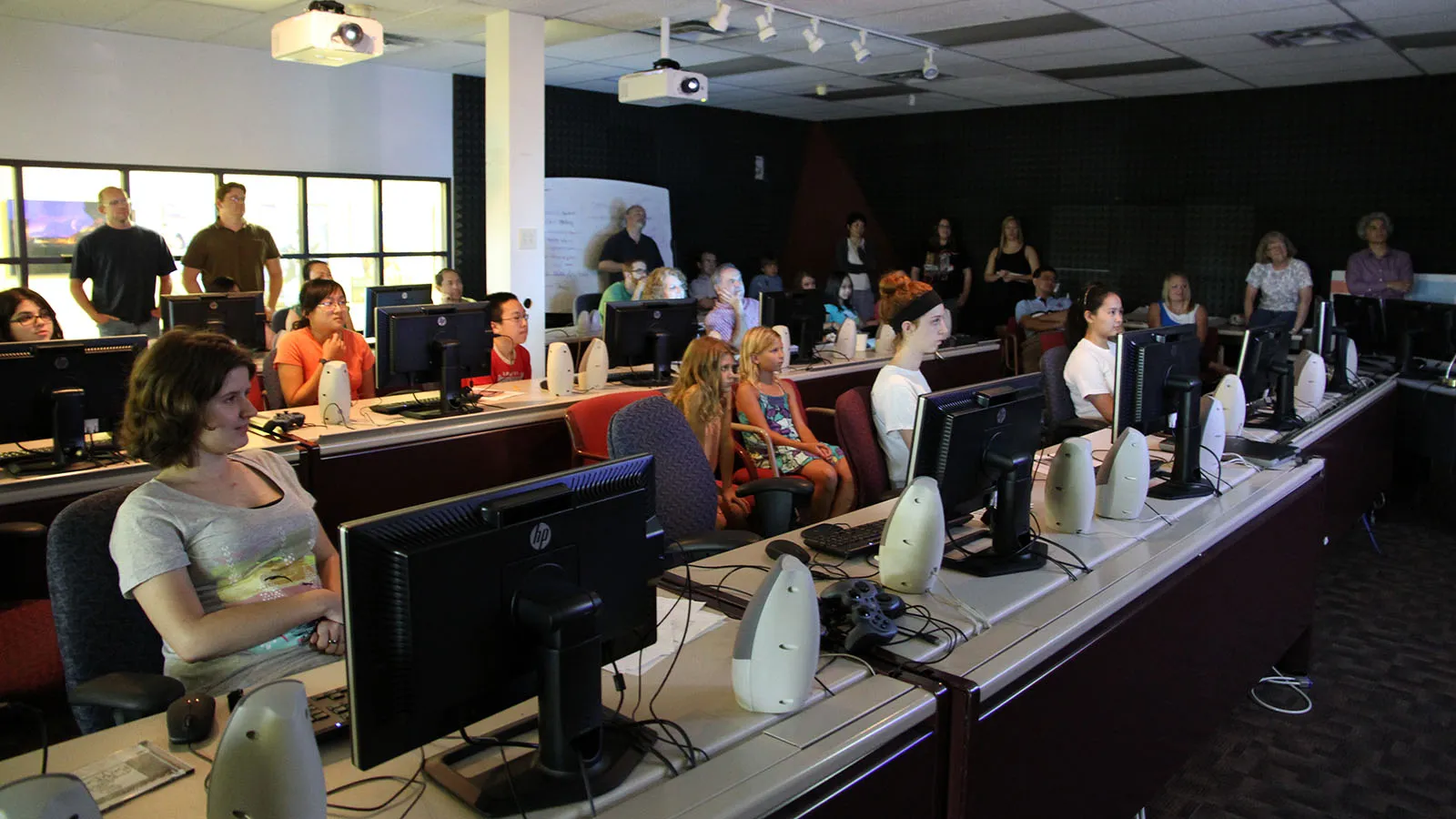 students, mentors, and family watching animation