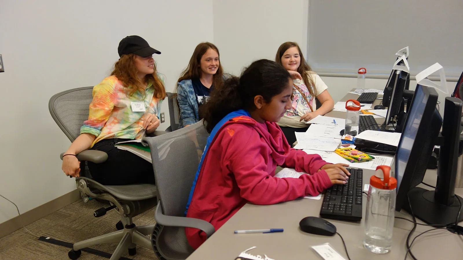 students and mentor working in computer lab