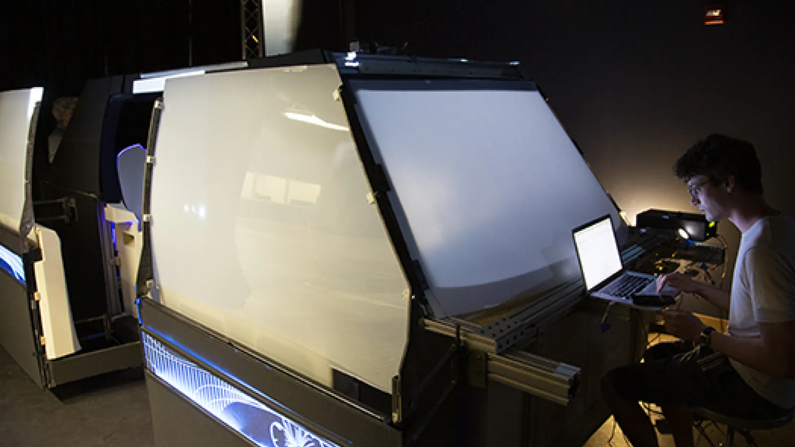 A team member works at his laptop on the autonomous vehicle project