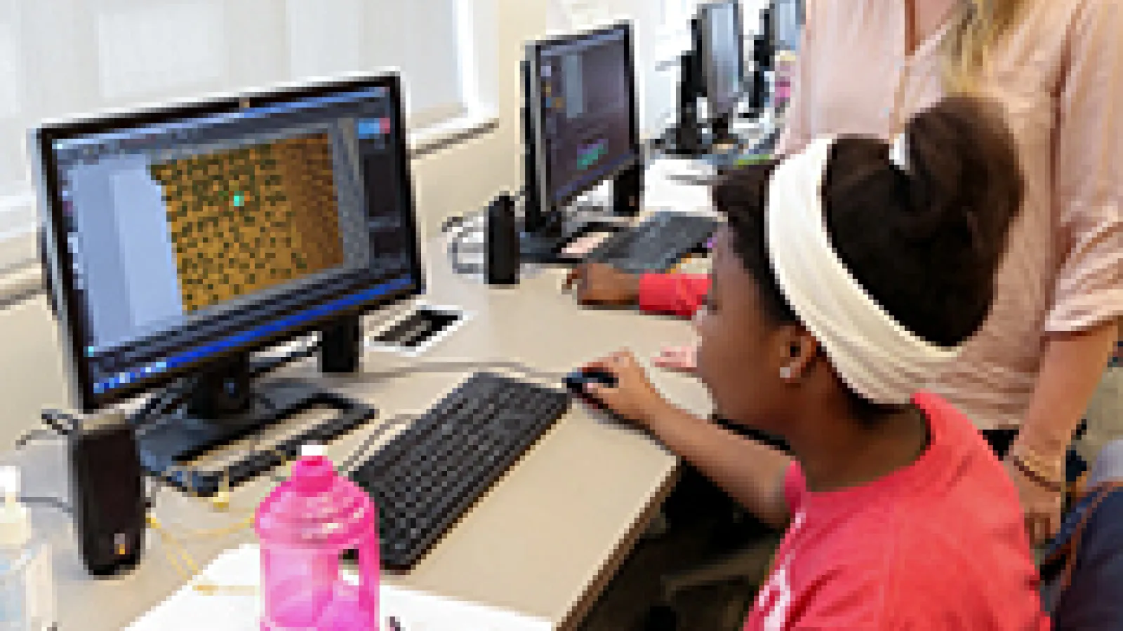 Malory mentoring younger woman on computer animation