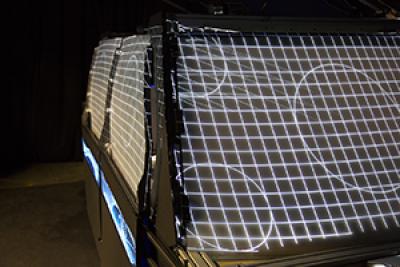 Autonomous vehicle buck exterior with light projections on windows