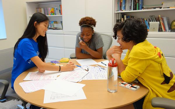 Students collaborating around a table.