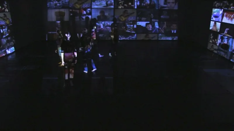 Actors on stage with multiple projected screens