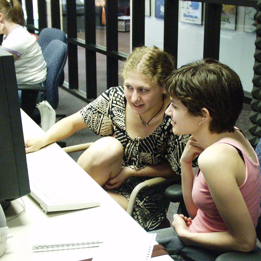 student and mentor working at computer