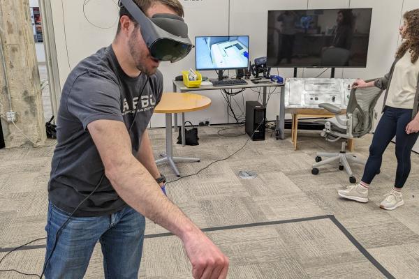 Person using a VR headset and interacting with an object in the VR space