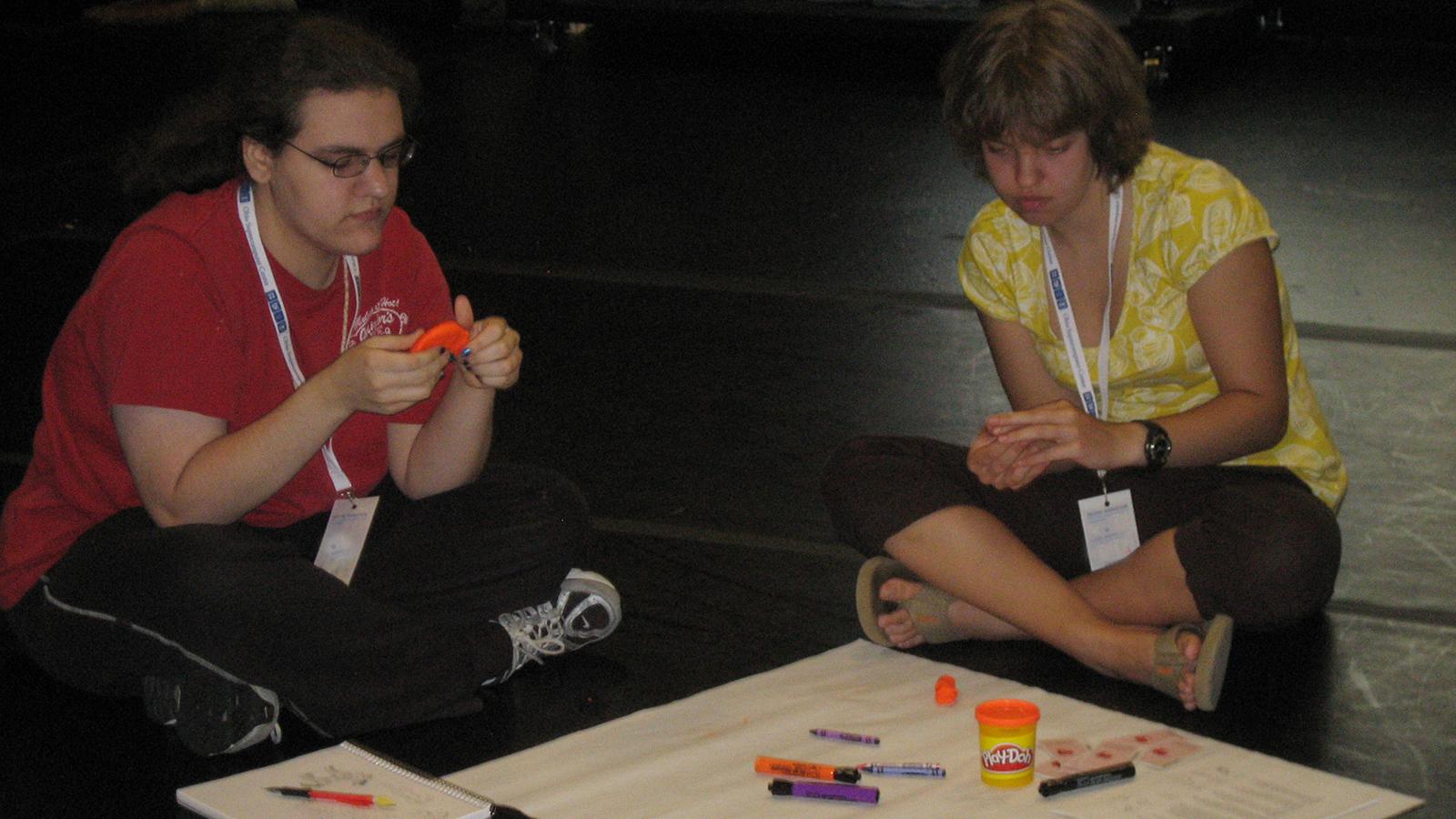 Two students working with play dough 