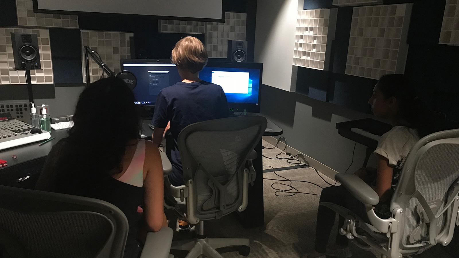 students and mentor working in sound studio