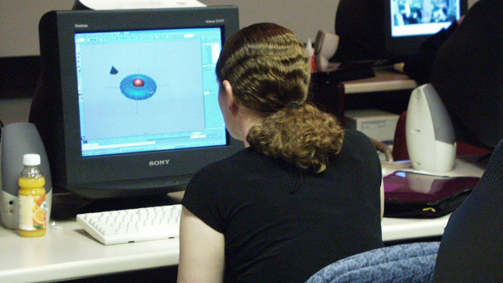 student at a computer working on animation