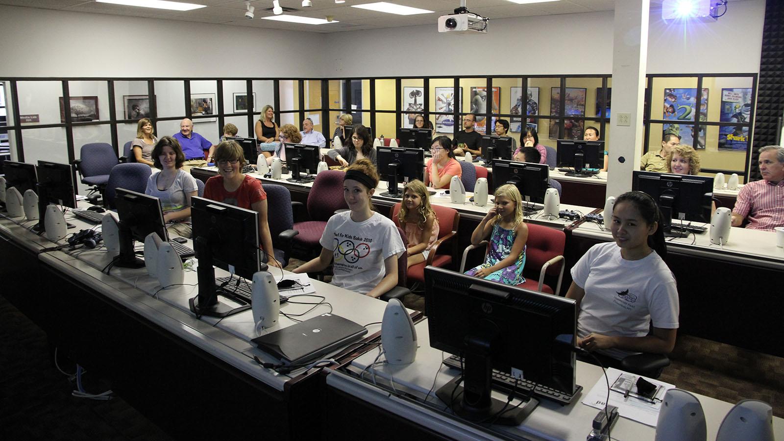 students and family in computer lab during final presentation