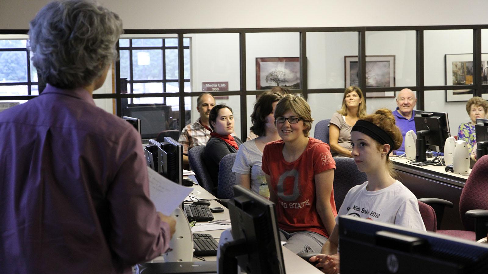 students and family in computer lab during final presentation