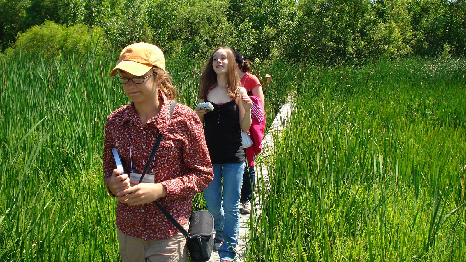 students walking through the wetlands