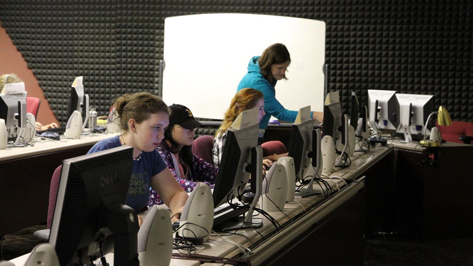 students and mentor working in computer lab