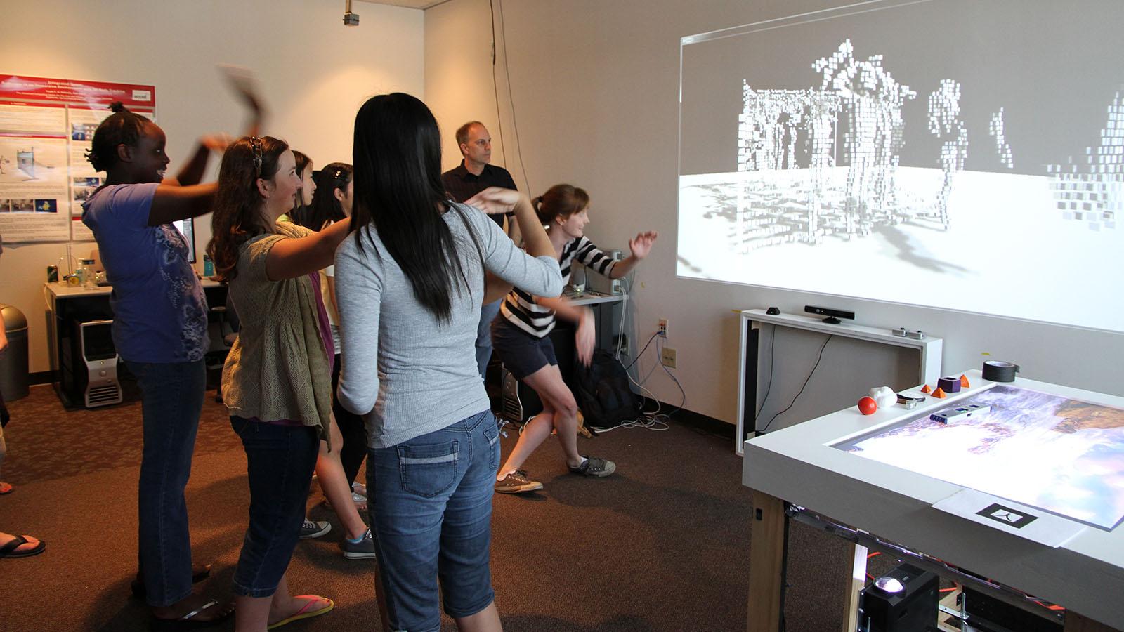 a group of student activating an interactive display through motion